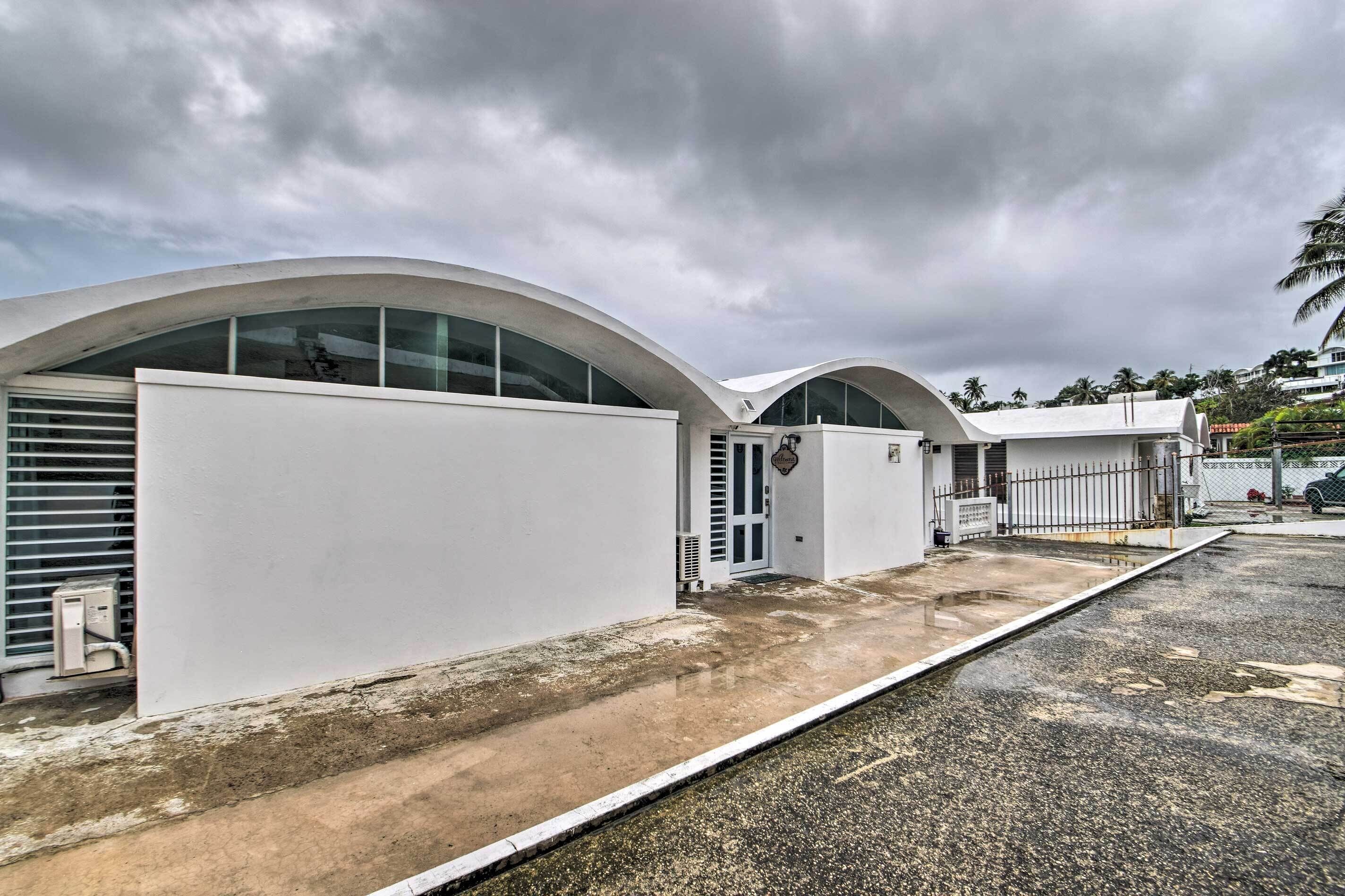A modern building with arched windows and a flat roof.