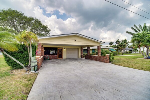 A single-story house with a garage, a covered porch, and a well-maintained lawn. - Fort Pierce Vacation Rental: Walk to Beach & Jetty (Fort Pierce)