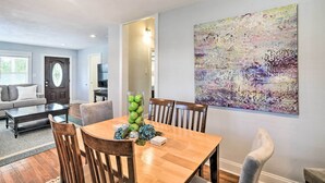 A dining area with a wooden table, chairs, and a vase of green apples. - ~ 1 Mi to Pier & Beaches! Family Home in Galveston (Galveston)