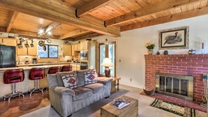 A cozy living room with a fireplace, a sofa, and a coffee table.