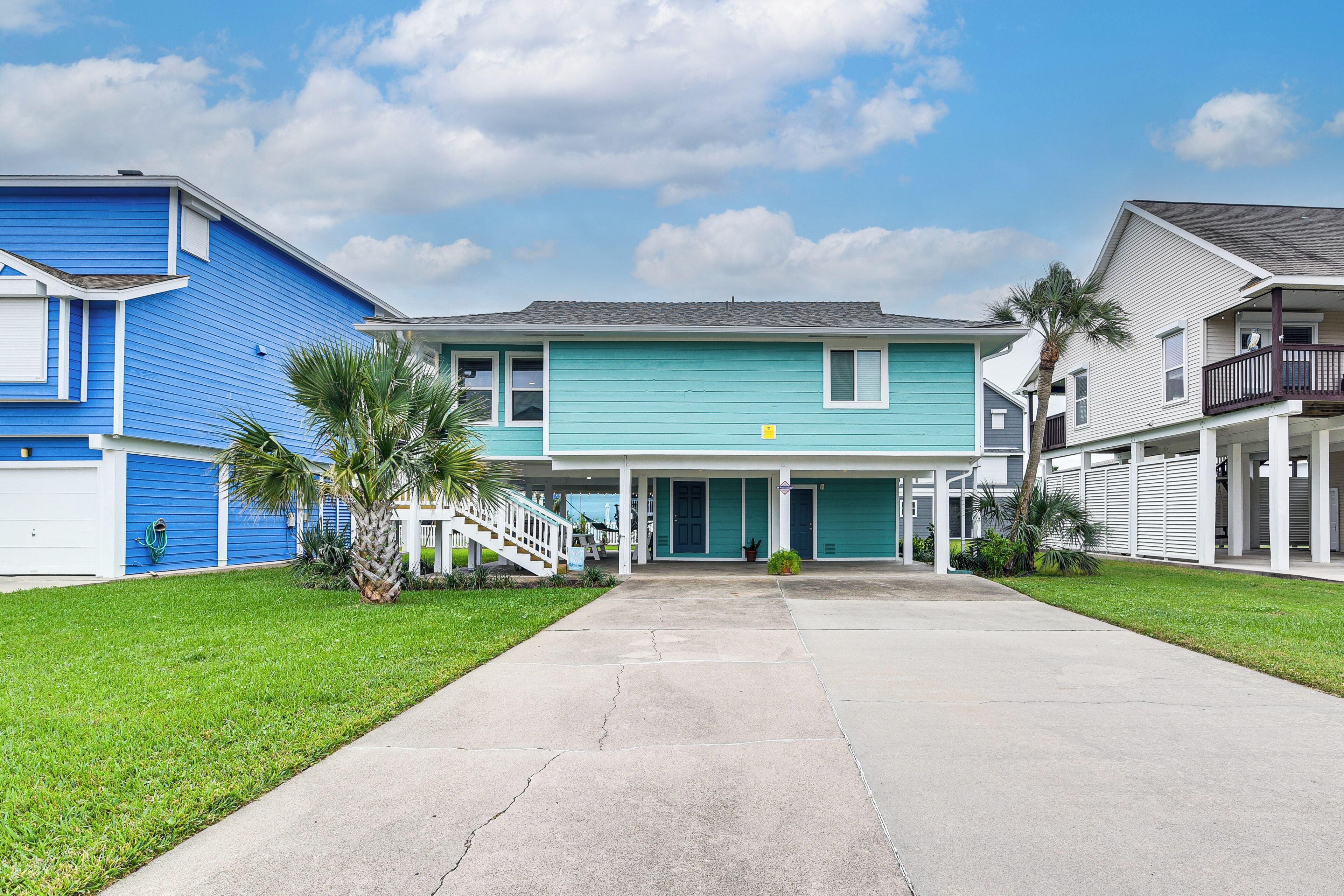 A two-story house with a front porch, a garage, and a well-maintained lawn.