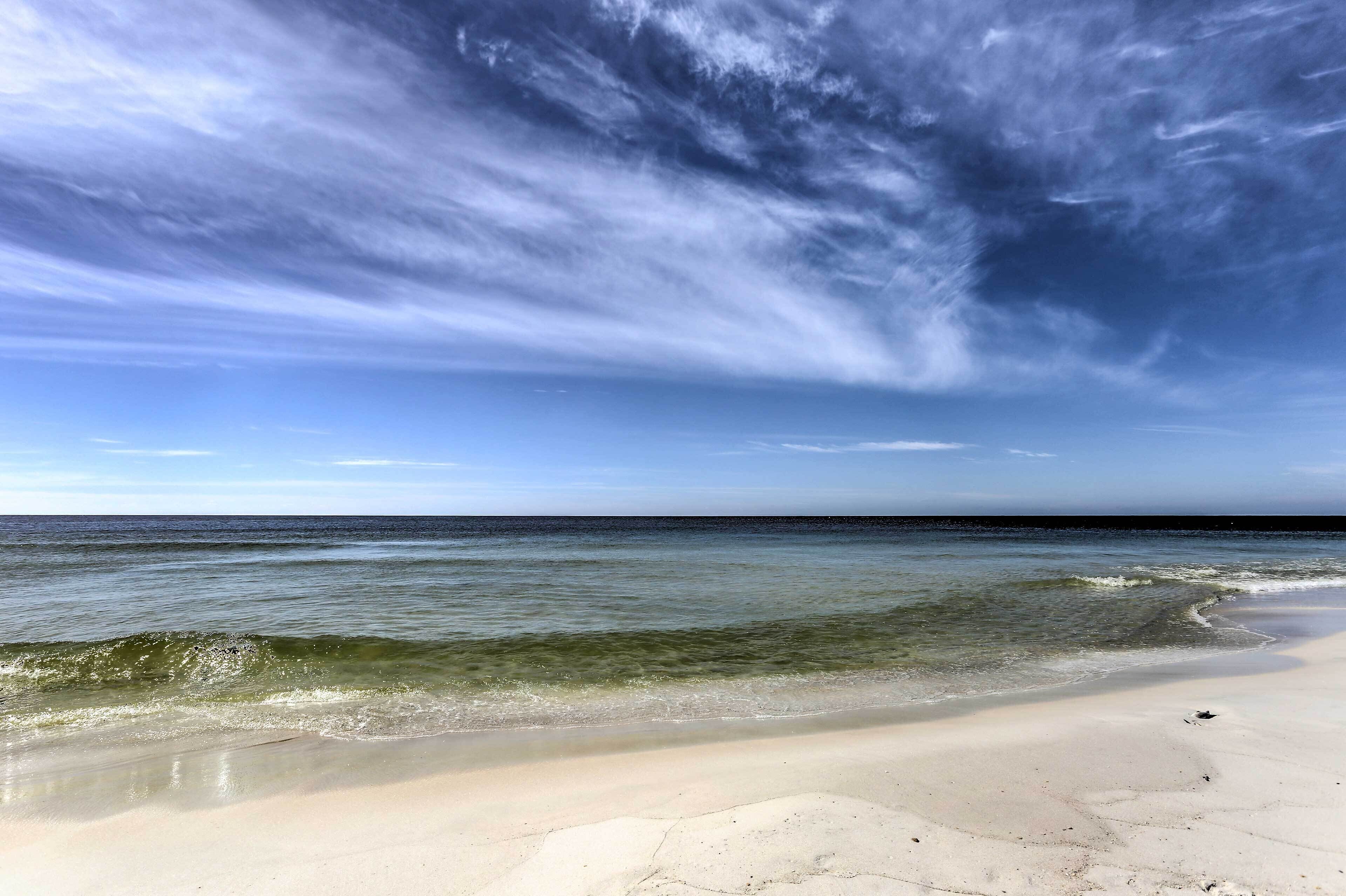 A beach with clear skies and calm waters.