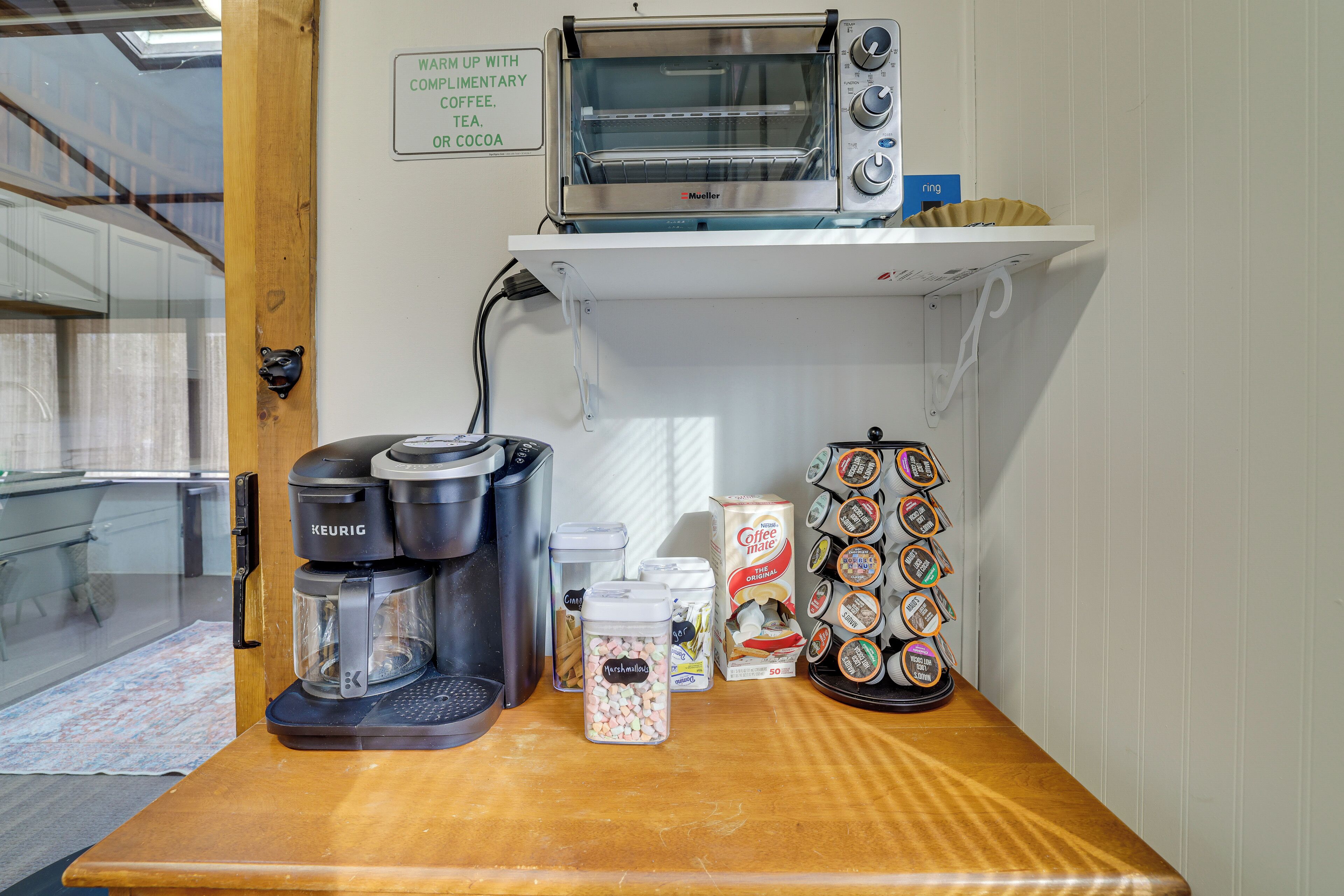 A kitchenette with a coffee maker, a toaster, and a coffee machine.