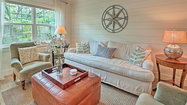 A living room with a sofa, armchairs, a coffee table, and a lamp. - Orlando Vacation Rental < 2 Miles to Lake Ivanhoe! (Orlando)