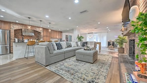 A modern kitchen with a brick backsplash, stainless steel appliances, and pendant lighting. - Outdoor Oasis! Group Getaway w/ Pool in Brandon (Brandon)