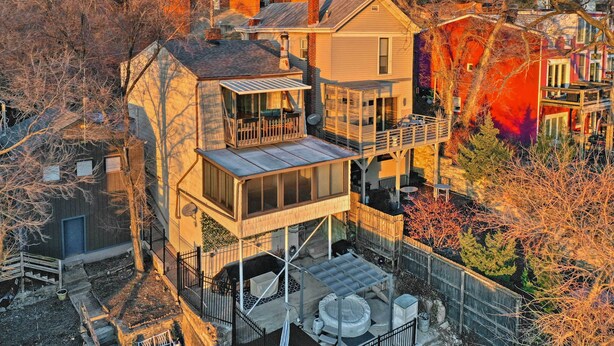 A multi-story house with a balcony, a fenced backyard, and a satellite dish. - Cincinnati Home, Patio w/ Downtown Views! (Cincinnati)