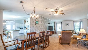 A spacious living area with a dining table, chairs, a sofa, and a TV. - 5 Mi to Homosassa Springs Park: Home w/ Yard! (Homosassa)