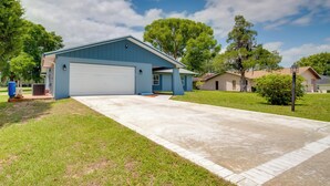 A residential house with a garage, a driveway, and a lawn. - Walk to Lake: Geataway w/ Yard in Inverness (Inverness)