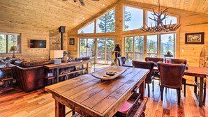 A spacious wooden cabin with a large dining table, leather seating, and a fireplace. - Jefferson Cabin w/ Fire Pit: Near Hiking Trails! (Como)