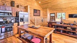 A wooden cabin interior with a kitchen, dining area, and a cozy seating space. - Jefferson Cabin w/ Fire Pit: Near Hiking Trails! (Como)