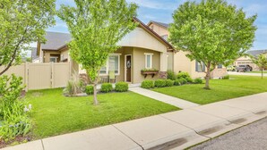 A single-story house with a front porch, a small front yard, and a driveway. - Charming Boise Home ~ 8 Mi to Downtown! (Garden City)