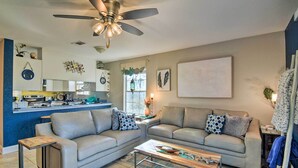 A living room with two sofas, a coffee table, a ceiling fan, and a kitchen area in the background. - 'breezy Heights' Townhome < 1 Mi to Beach (Pensacola)