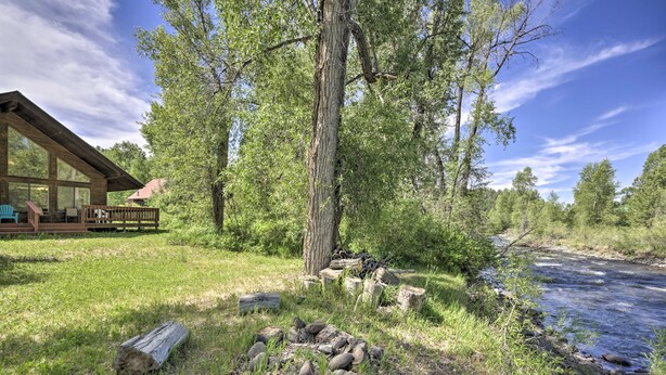 A cabin with a deck, a fire pit, and a river. - 'the River Home' Cabin w/ Yard: Near Wolf Creek! (Pagosa Springs)