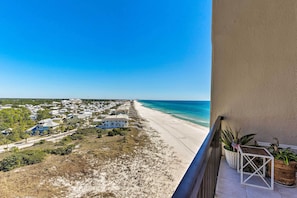 A balcony with a view of a beach and residential area. - PCB Beachfront 'coastal Abode' at Pinnacle Port! (Panama City Beach)