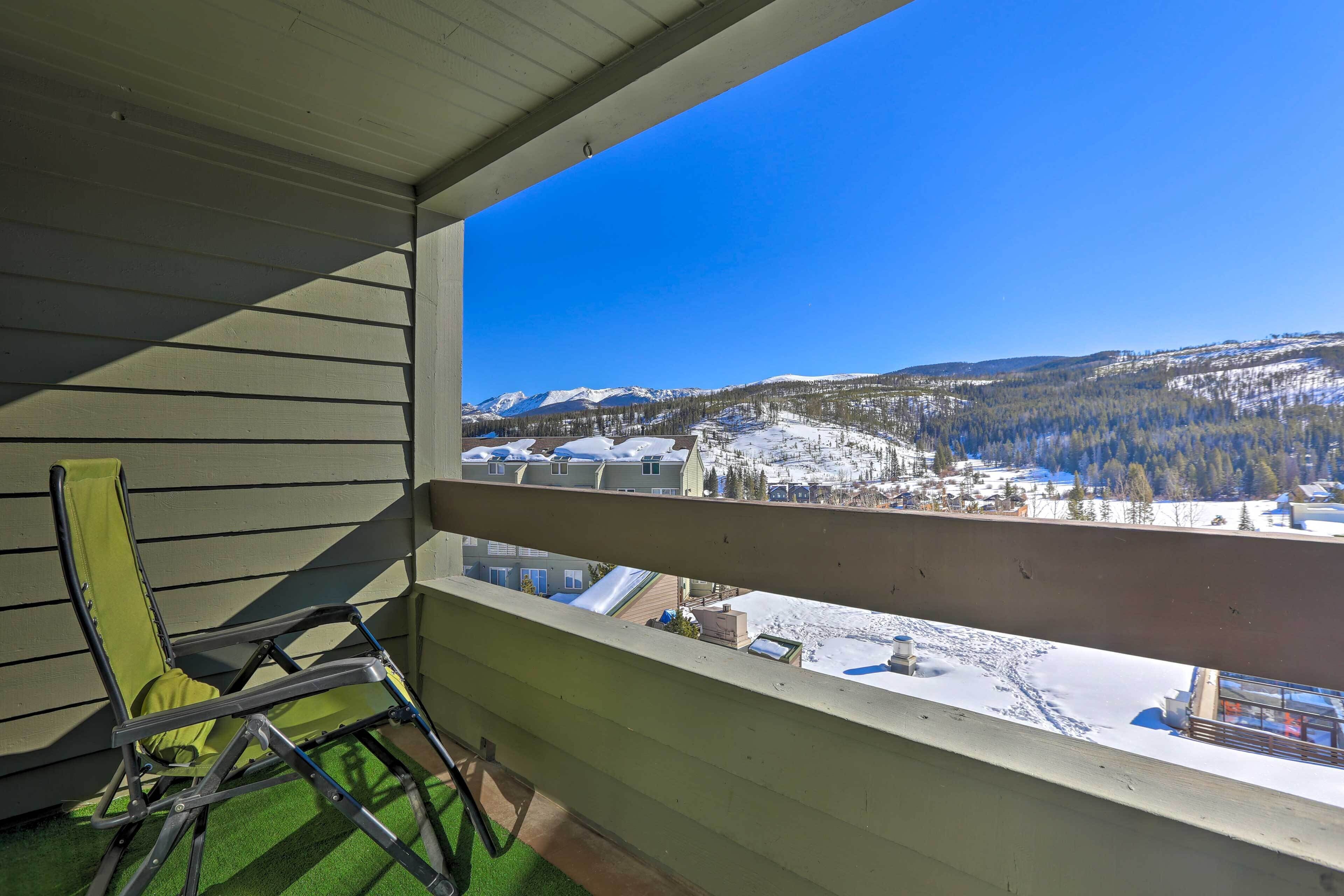 A balcony with a view of a snowy landscape and mountains.