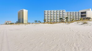A beachfront hotel with multiple high-rise buildings, sandy beach, and palm trees. - PCB Coastal Condo w/ On-site Beach Access! (Panama City Beach)