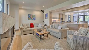 A spacious living area with a sofa, armchairs, a coffee table, and a fireplace. - Luxurious Home, Walk to Beaver Creek Gondola! (Avon)