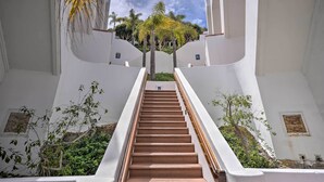 A staircase with white walls and wooden steps leading upwards. - Quiet Avalon Getaway Villa w/ Ocean View & Balcony (Avalon)