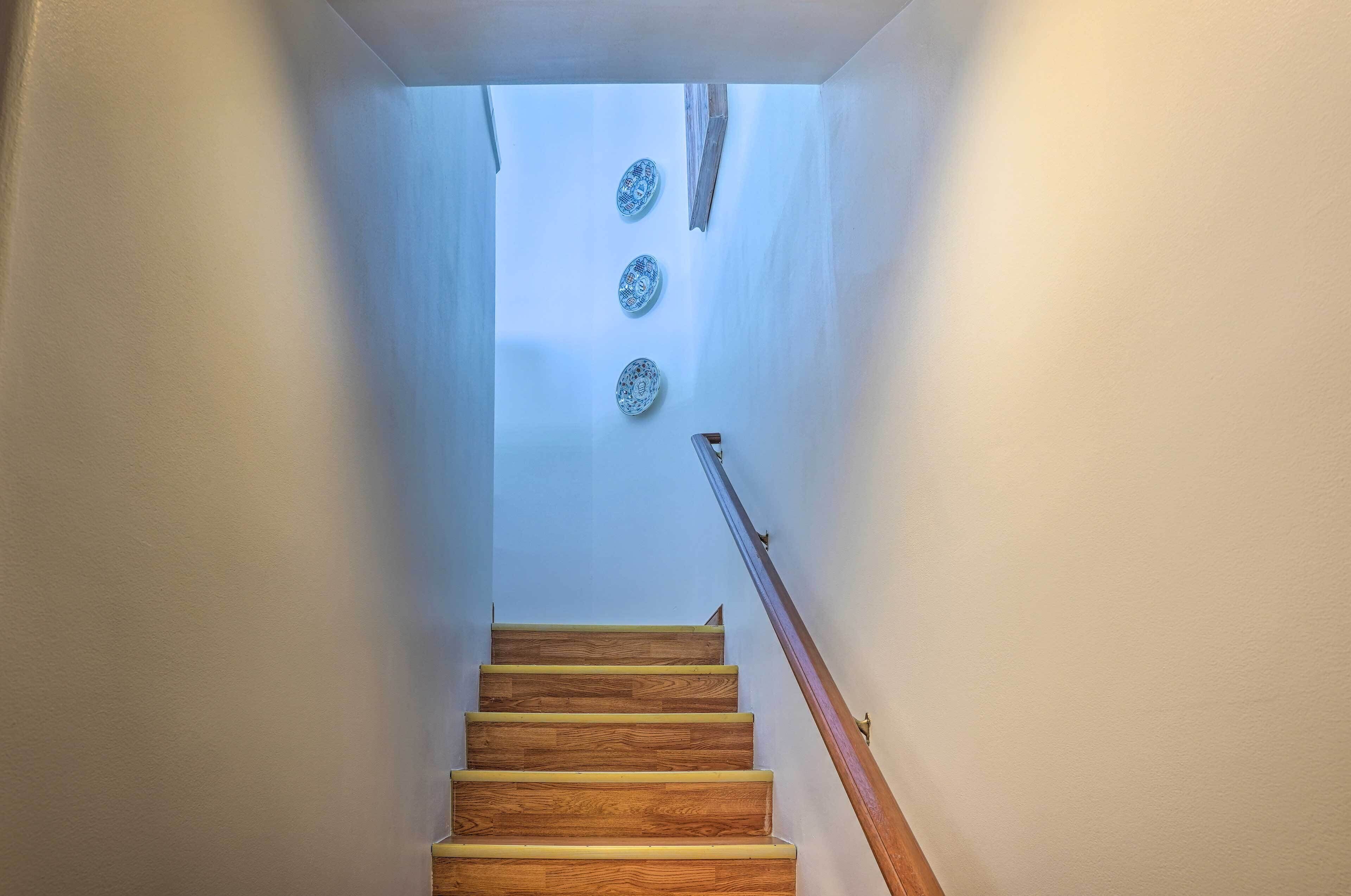 A staircase with wooden steps and a wooden handrail.