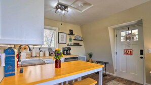A kitchen with a wooden countertop, white stools, a sink, and a coffee maker. - Lake Arrowhead Studio Near Hiking w/ Hot Tub (Lake Arrowhead)