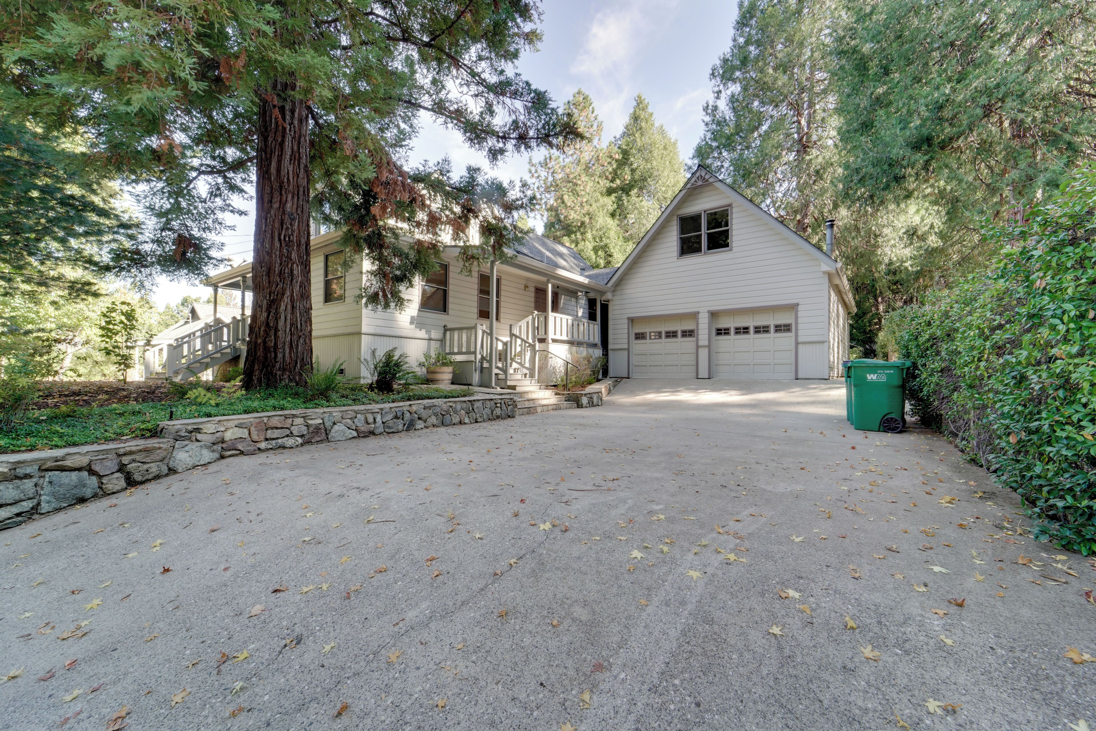 A two-story house with a covered porch and a garage.