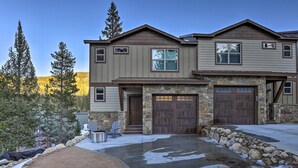 A two-story house with a stone foundation, a garage, and a driveway with a stone border. - Mountain View Retreat, Walk to Winter Park Gondola (Winter Park)