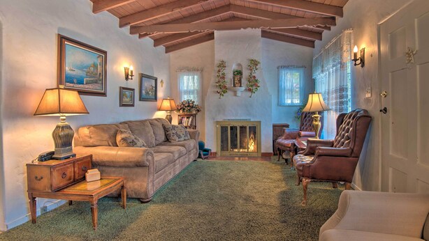 A cozy living room with a fireplace, a sofa, a chair, and a table. - Avalon Escape: Everything Within Walking Distance! (Avalon)