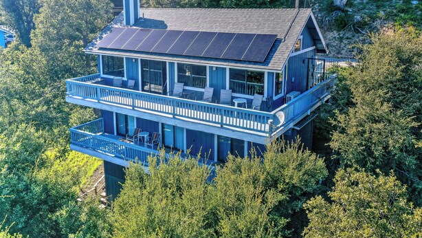 A two-story house with a balcony and solar panels. - The Atomic Squirrel Lodge Lake Gregory Getaway! (Crestline)