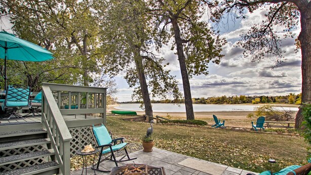 A patio with outdoor furniture, a fire pit, and a view of a lake. - Lakefront Fort Collins Townhome, Only 3 Mi to Csu! (Fort Collins)