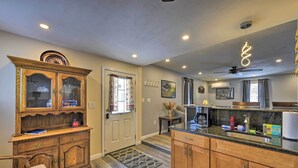 A kitchen with wooden cabinets, a granite countertop, and a ceiling fan.