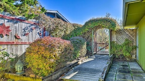 A wooden pathway leading to a house with a wooden fence and a Buddha statue. - Pet-friendly Eureka Home ~ 6 Mi to Old Town! (Eureka)