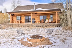 A log cabin with a deck, outdoor seating, and a fire pit. - Mountain Views & Fire Pit: Granby Retreat! (Granby)