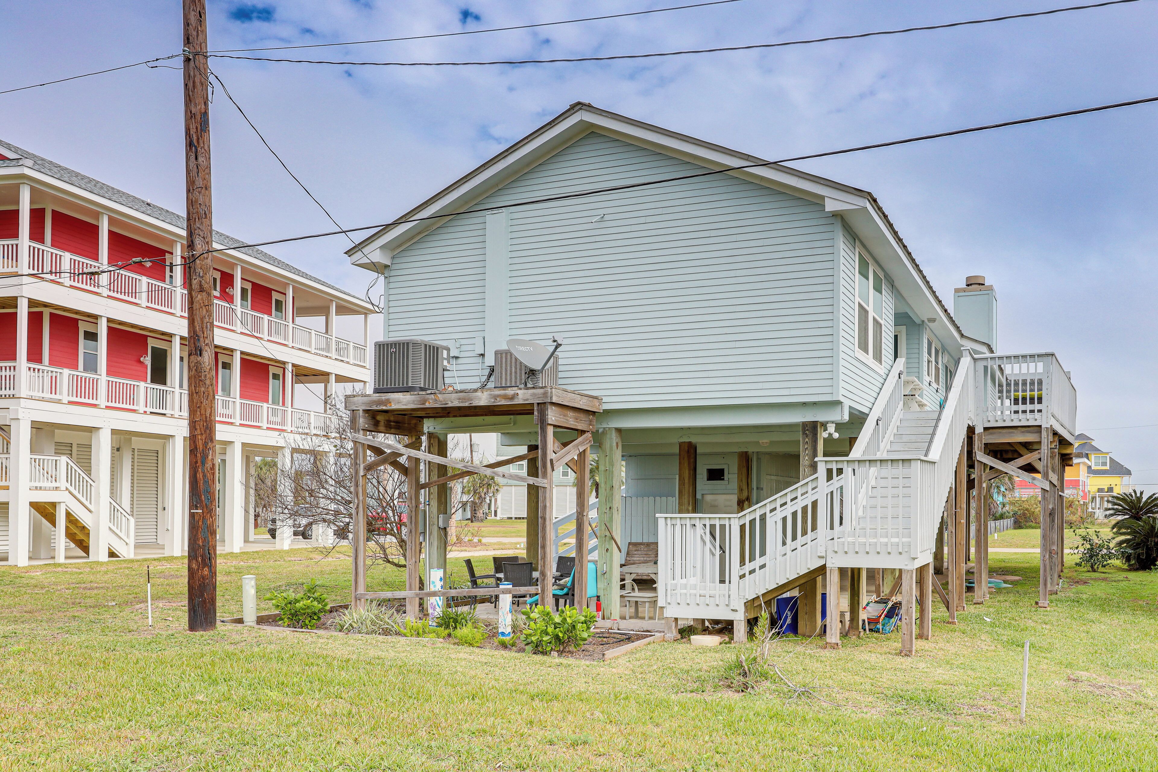 A two-story building with a porch and a staircase leading to a deck.