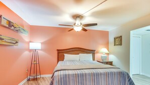A bedroom with a bed, a standing lamp, a ceiling fan, and a floor lamp. - PCB Vacation Rental w/ Sweeping Ocean Views! (Panama City Beach)