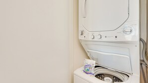 A front-loading washing machine with a detergent pod on top. - PCB Vacation Rental w/ Sweeping Ocean Views! (Panama City Beach)