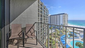 A balcony with a view of a beach and a pool area. - PCB Vacation Rental w/ Sweeping Ocean Views! (Panama City Beach)