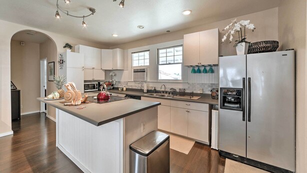 A modern kitchen with a central island, stainless steel appliances, and a large window providing natural light. - Hawaiian Hideaway w/ Yard < 2 Miles to Hilo Bay! (Hilo)