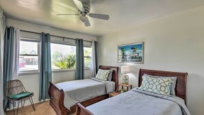 A bedroom with two beds, a ceiling fan, a window with curtains, a chair, and a small table with a lamp. - Vintage Las Vegas Oasis < 3 Mi to the Strip! (Las Vegas)