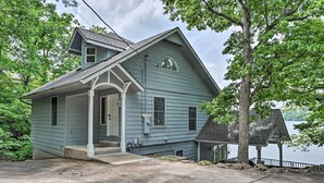 A two-story house with a porch, a small deck, and a view of a lake. - Sunny 'providence Cottage' Retreat w/ Dock, Kayaks (Sunrise Beach)