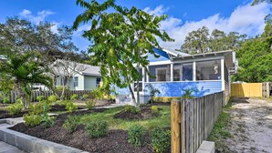 A residential property with a blue roof, a fenced backyard, and a garden area. - Bright Bradenton Retreat: 1 Mi to Downtown! (Bradenton)