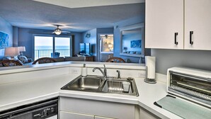 A modern kitchen with a built-in dishwasher, double sink, and a built-in oven. - Oceanfront Condo Rental Near Daytona Speedway (Ormond Beach)