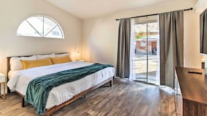 A bedroom with a bed, a desk, a window, and a view of the outside. - 2 Mi to Coachella: Indio Getaway w/ Outdoor Oasis! (Indio)