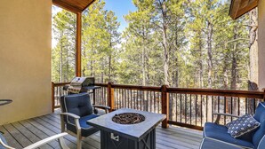 A covered outdoor deck with a grill, seating, and a fire pit. - Beautiful Pagosa Springs Home w/ Deck & Grill (Pagosa Springs)