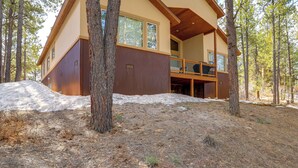 A modern two-story cabin with a wooden deck, surrounded by trees and a snowy landscape. - Beautiful Pagosa Springs Home w/ Deck & Grill (Pagosa Springs)