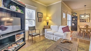 A living room with a fireplace, a sofa, a coffee table, and a bookshelf.