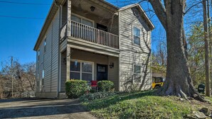 A two-story house with a balcony, a front porch, and a garage.