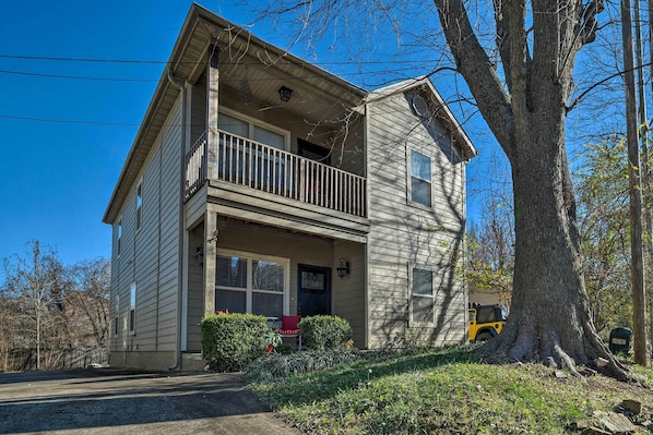 A two-story house with a balcony, a front porch, and a garage.