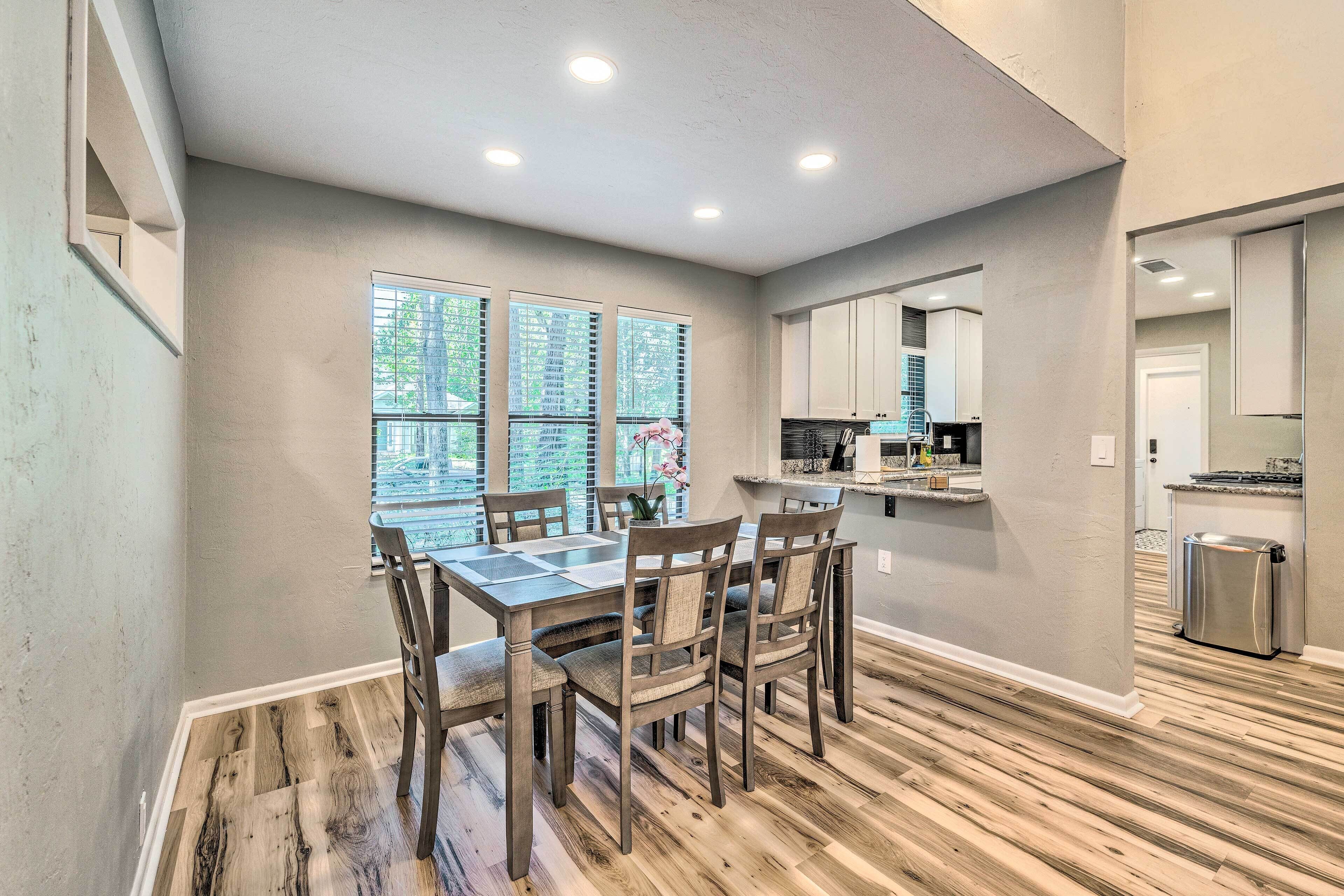 A modern kitchen with a dining area.