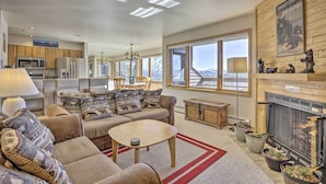 A spacious living room with a fireplace, large windows, and a cozy seating area. - Condo w/ Views & Hot Tub Access in Silverthorne! (Silverthorne)