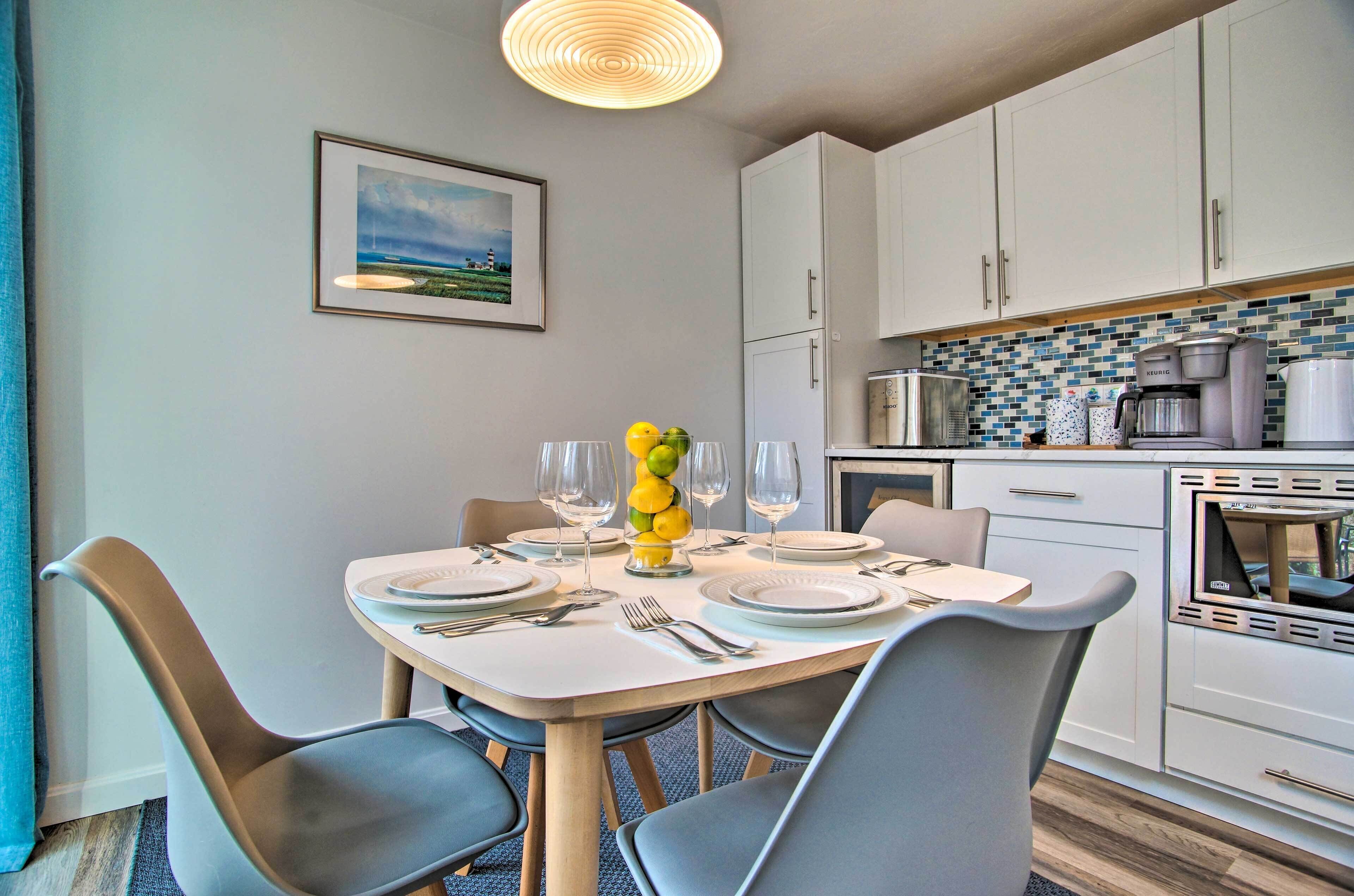 A modern kitchen with white cabinets, a coffee maker, and a microwave.